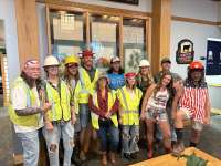 
                  Group of construction workers smiling for a photo