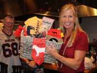 
                  Big Brother Big Sisters supporters holding gift basket