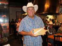 
                  Cowboy holding custom cutting board and chopsticks