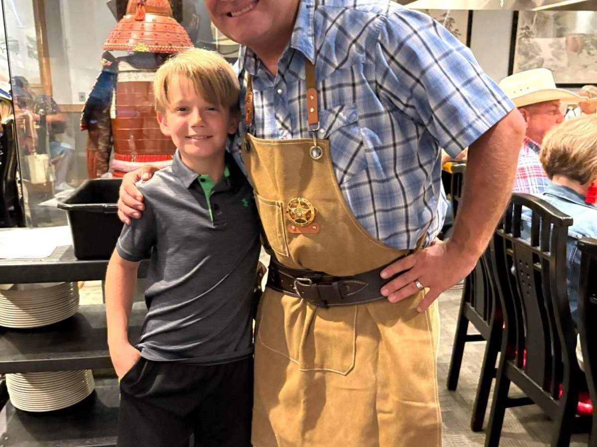 Cowboy and child take a smile for a photo