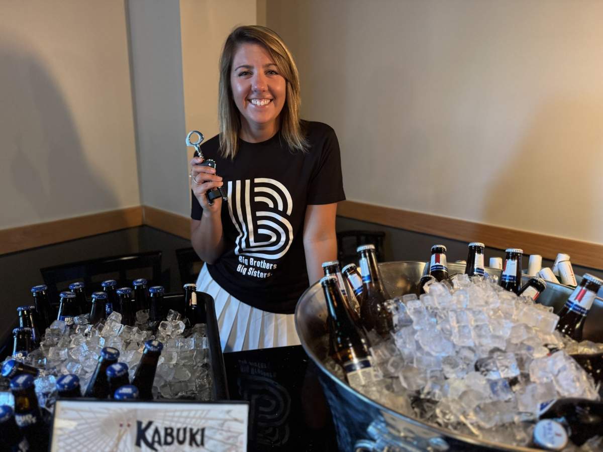 Big Brother Big Sister worker holding drinks