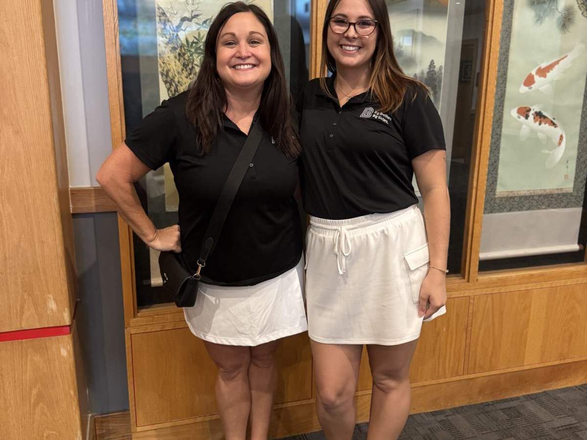 Two people in black shorts and white skirts
