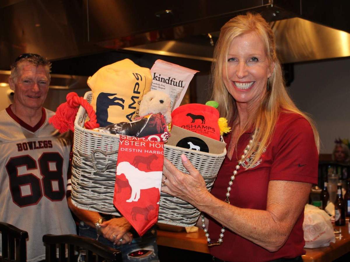 Big Brother Big Sisters supporters holding gift basket
