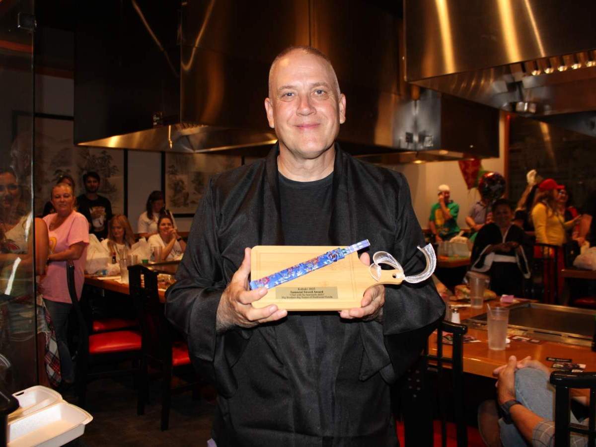 Person holding custom cutting board and chopsticks