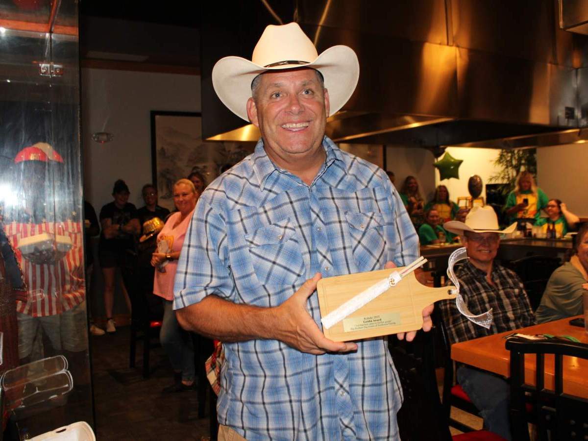Cowboy holding custom cutting board and chopsticks