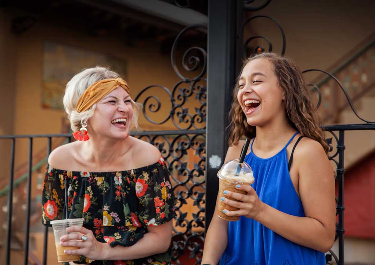 Little and Big enjoying lattes and laughing