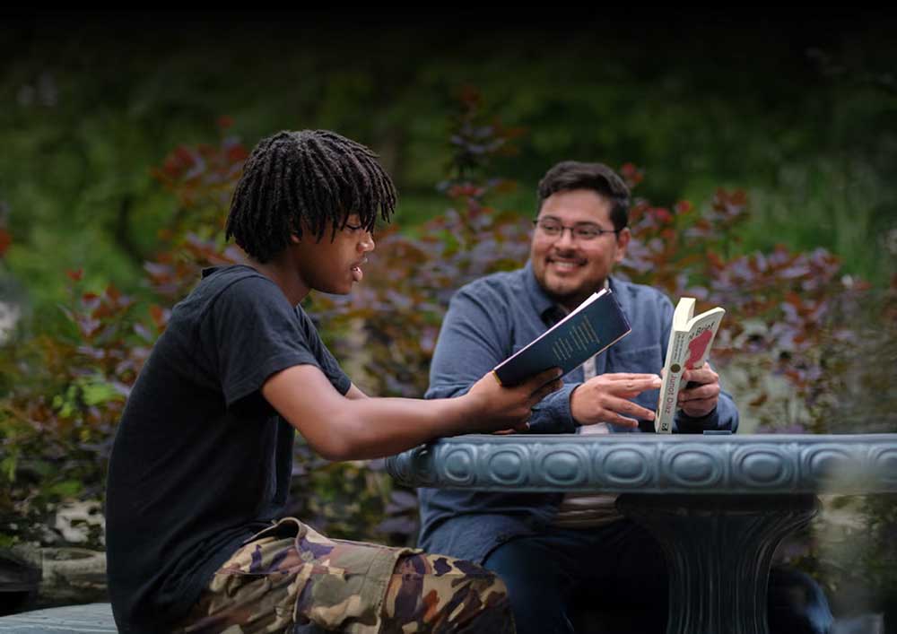Little and Big reading in the park together